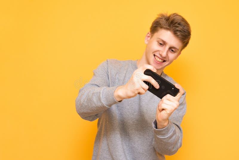 Young Boy and Girl Play Games and Listen To Music on Mobile Phones Stock  Photo - Image of hand, gamer: 135473906