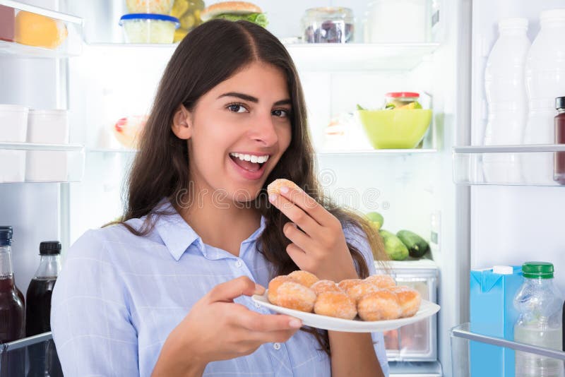 Smiling Woman Eating Cookies In Plate