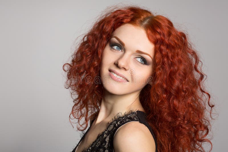 Portrait smiling young woman with red hair