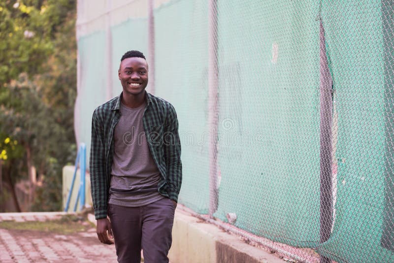 Portrait of stylish happy african american man on sportswear,green shirt walking. Black men model street fashion. royalty free stock photo Portrait of stylish happy african american man on sportswear,green shirt walking. Black men model street fashion. royalty free stock photo