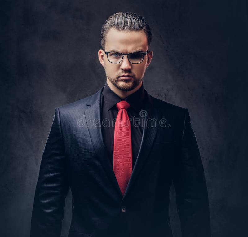 Portrait of a Stylish Male in a Black Suit and Red Tie. Isolated on a ...