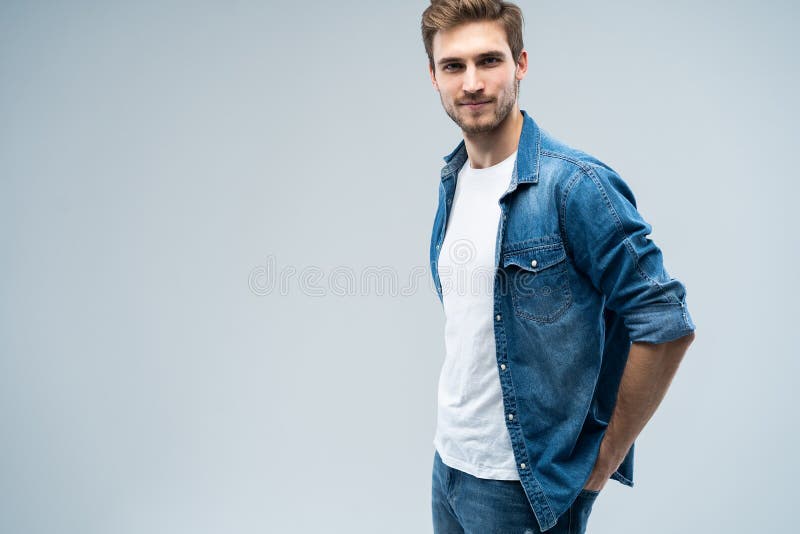 Portrait of Stylish, Stunning Man in Denim Outfit Standing Over Grey ...