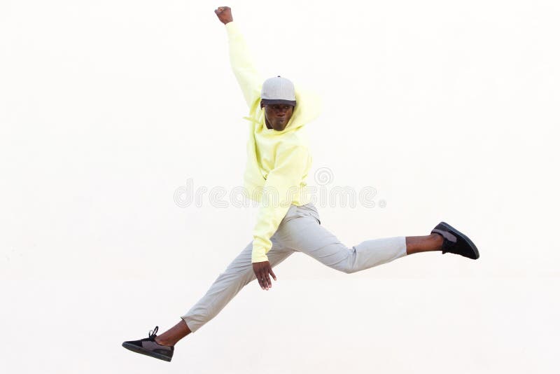 Stylish young African American man jumping and dancing on white background royalty free stock image Stylish young African American man jumping and dancing on white background royalty free stock image