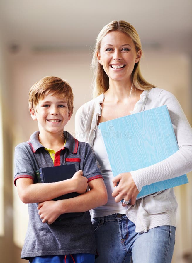Portrait, teacher and boy walking, hallway and books with education, knowledge and happiness. Face, female person and stock photos