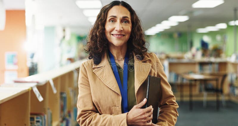 Portrait, teacher and woman with smile, education and confident for curriculum in elementary and school. Happy, educator stock photo