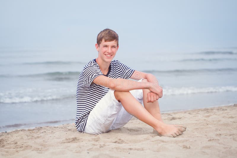 Boy Sitting on Sand at Beach Stock Photo - Image of sand, sitting: 33378018
