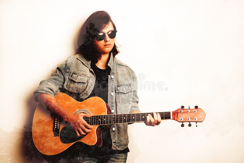 Portrait of a teenager playing guitar in studio.