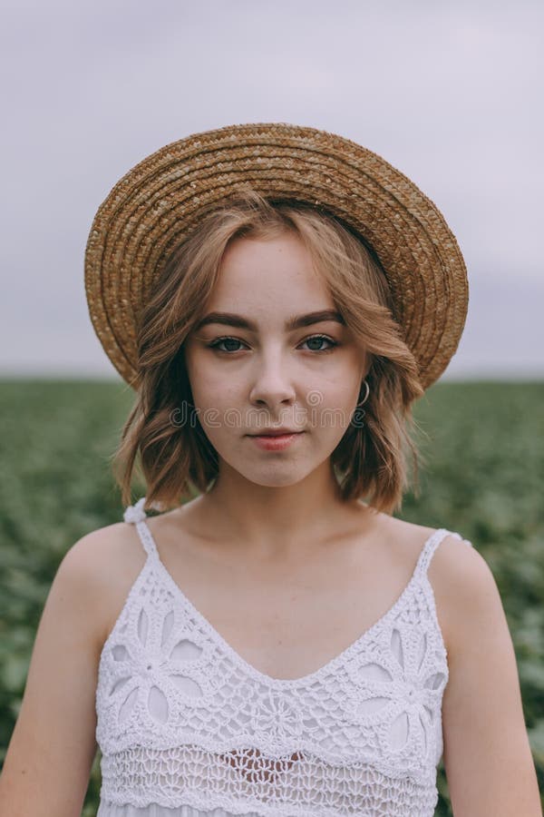 Portrait of Tender Beautiful Young Blonde Girl in Straw Brown picture