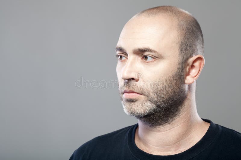 Portrait of thoughtful mature caucasian man isolated on gray royalty free stock photography