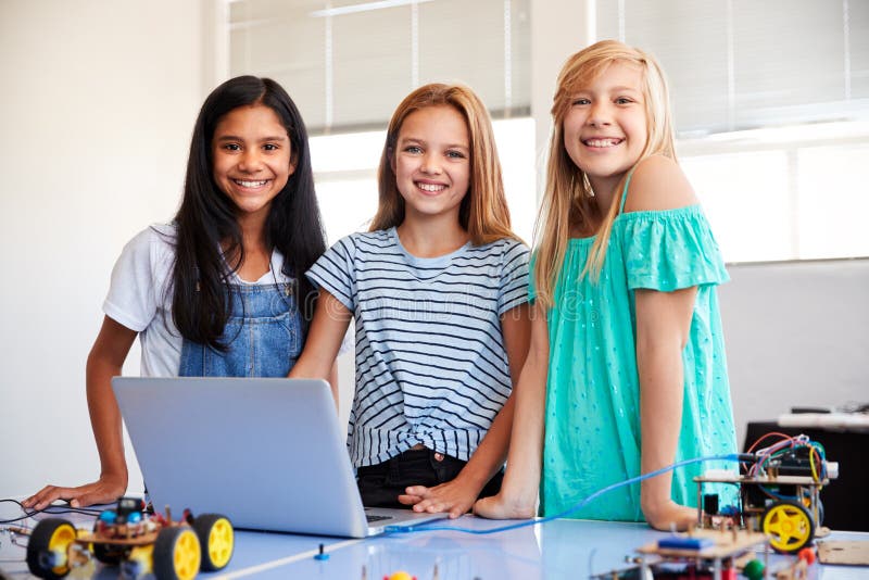 Portrait Of Three Female Students Building And Programing Robot Vehicle In School Computer Class royalty free stock image