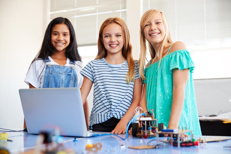 Portrait Of Three Female Students Building And Programing Robot Vehicle In School Computer Class stock image