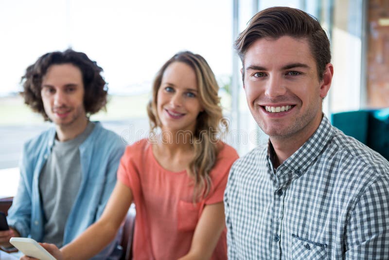 Portrait of three friends sitting in coffee shop stock photos