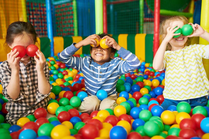 Happy Kids Playing in Ball Pit