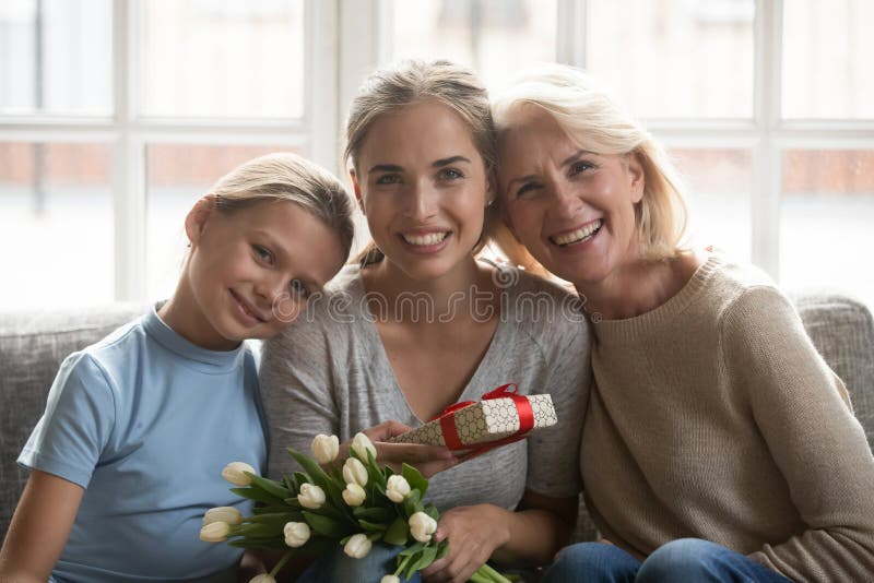 Portrait of three generations of women celebrate together