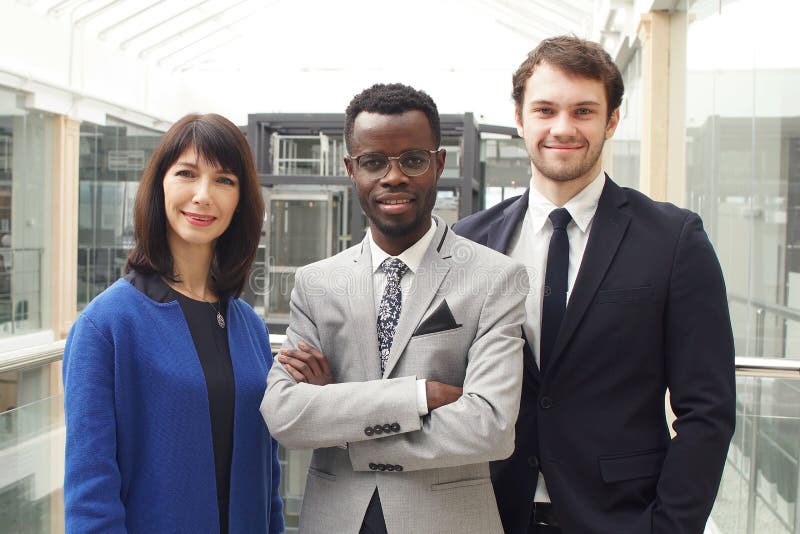 Portrait of three successful businesspeople, business team posing in modern office royalty free stock images Portrait of three successful businesspeople, business team posing in modern office royalty free stock images