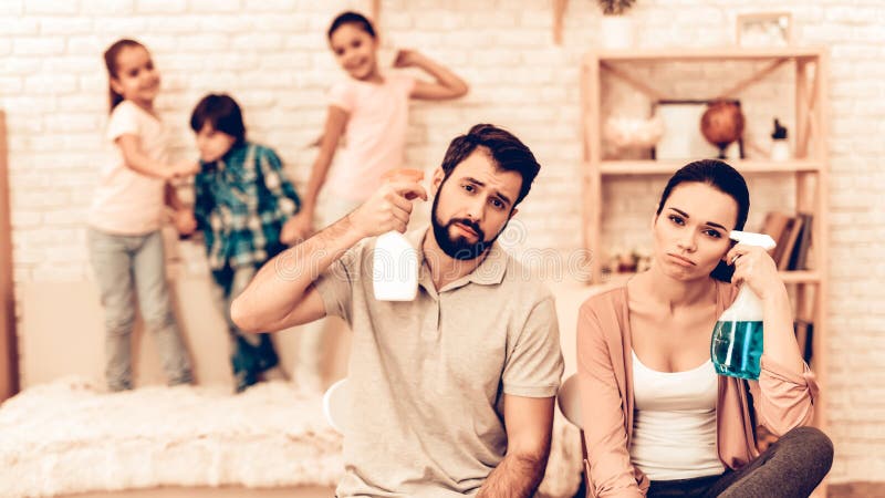 Portrait of Tired Parents After Cleaning Home. stock photo Portrait of Tired Parents After Cleaning Home. stock photo