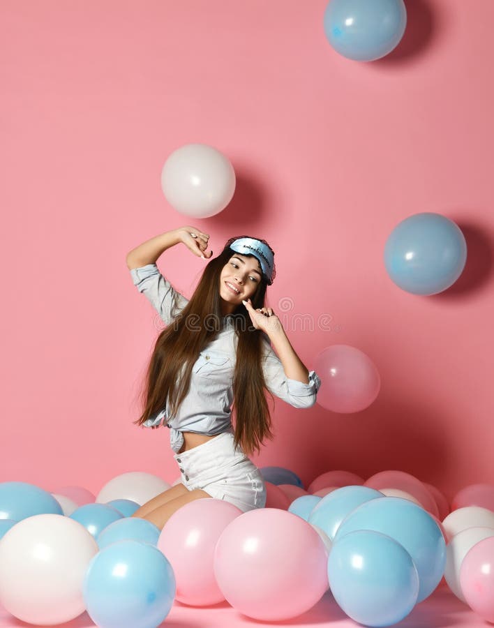Portrait of trendy cheerful young woman having many color air balloons looking up enjoying ballons on pink background. stock images Portrait of trendy cheerful young woman having many color air balloons looking up enjoying ballons on pink background. stock images