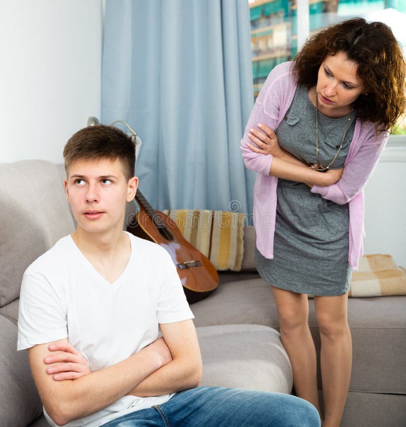 Troubled Teen Boy Sitting at Home while His Mother Scolding Him Stock ...