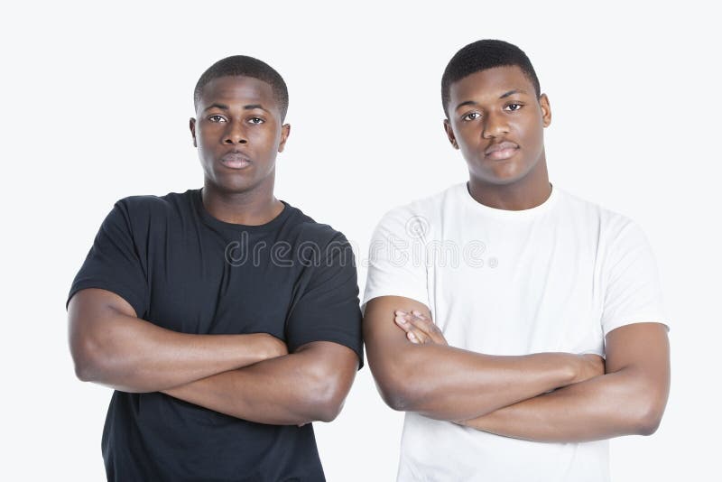 Portrait of two African American male friends with arms crossed over gray background royalty free stock photo Portrait of two African American male friends with arms crossed over gray background royalty free stock photo