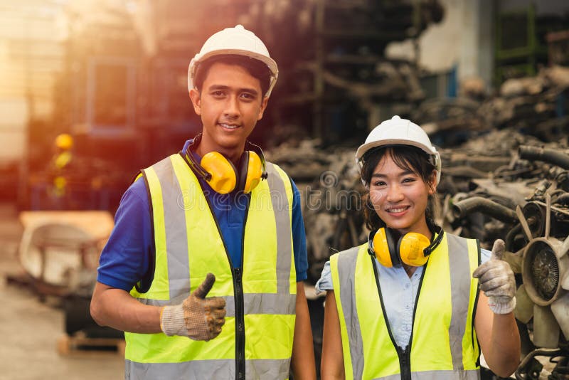 Portrait two Asian young man and women worker thumbs up couple friend team engineer working standing together happy smile to work royalty free stock photography
