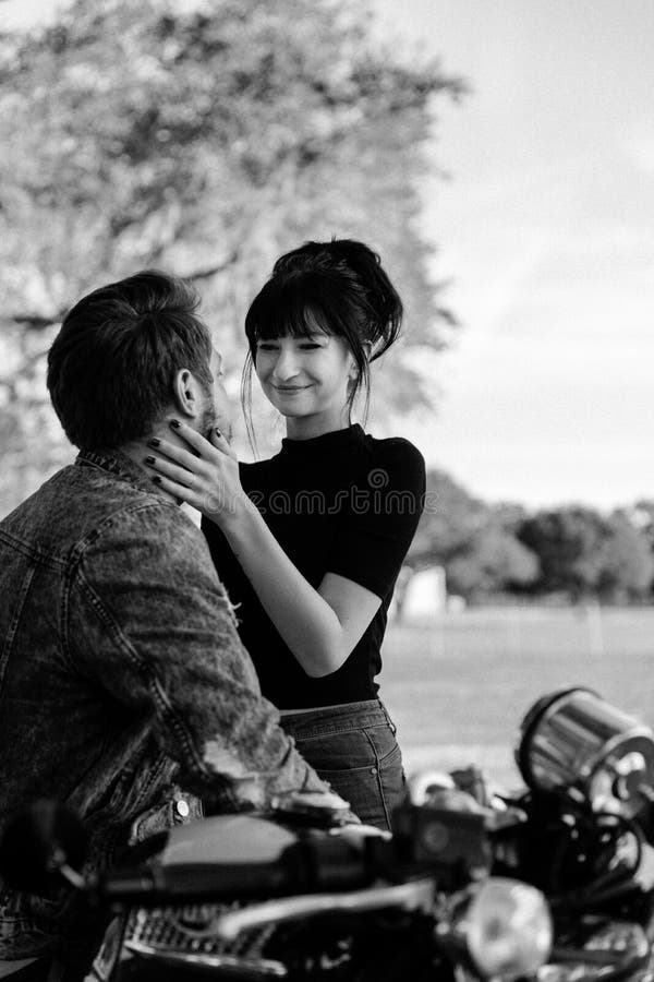 Portrait of two Attractive Good Looking Young Adult Modern Fashionable People Guy Girl Couple on Classic Green Motorcycle Hugging royalty free stock photo Portrait of two Attractive Good Looking Young Adult Modern Fashionable People Guy Girl Couple on Classic Green Motorcycle Hugging royalty free stock photo