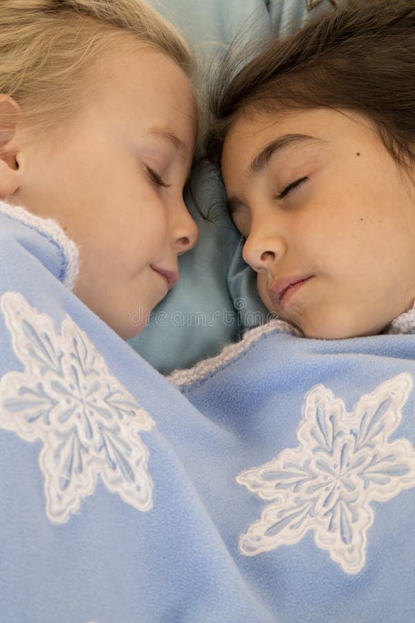 Portrait of two beautiful young girls asleep in bed stock images Portrait of two beautiful young girls asleep in bed stock images