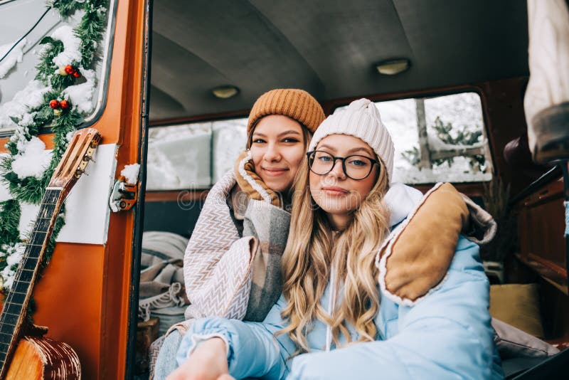 Portrait of Two Cheerful Young Women Friends Sitting in a Van in Winter ...