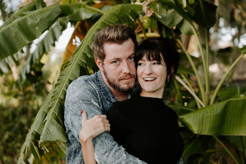 Portrait of Two Cute Modern Caucasian Beautiful Young Adult Guy Boyfriend Lady Girlfriend Couple Hugging and Kissing in Love in Na stock photo Portrait of Two Cute Modern Caucasian Beautiful Young Adult Guy Boyfriend Lady Girlfriend Couple Hugging and Kissing in Love in Na stock photo