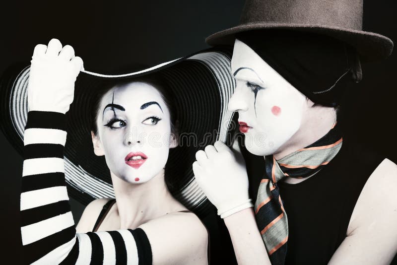 Portrait of two flirting mimes on a black background royalty free stock photos Portrait of two flirting mimes on a black background royalty free stock photos