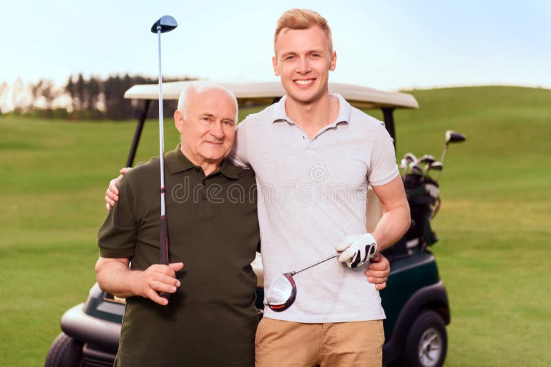 Portrait of two golfers on cart background