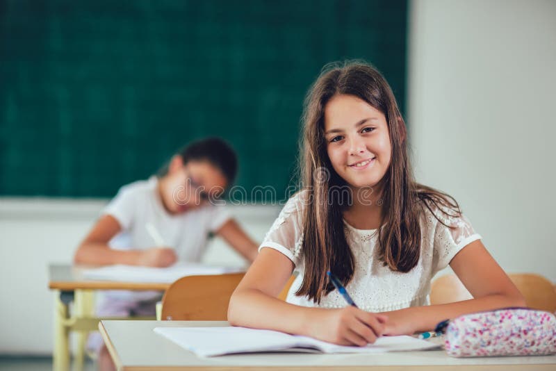 Portrait of happy schoolgirls in a classroom royalty free stock photography Portrait of happy schoolgirls in a classroom royalty free stock photography