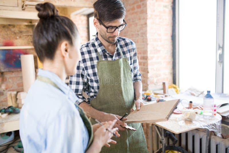 Two Artisans Discussing Work in Joinery Shop royalty free stock images Two Artisans Discussing Work in Joinery Shop royalty free stock images
