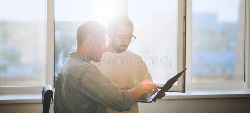 Portrait of two professional male programmers working on computer in diverse offices. Modern IT technologies royalty free stock images