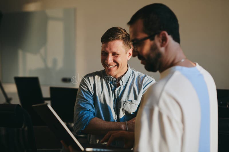 Portrait of two professional male programmers working on computer in diverse offices. Modern IT technologies stock photo