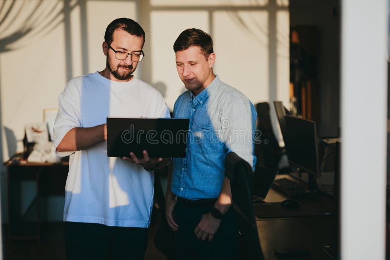 Portrait of two professional male programmers working on computer in diverse offices. Modern IT technologies royalty free stock photos