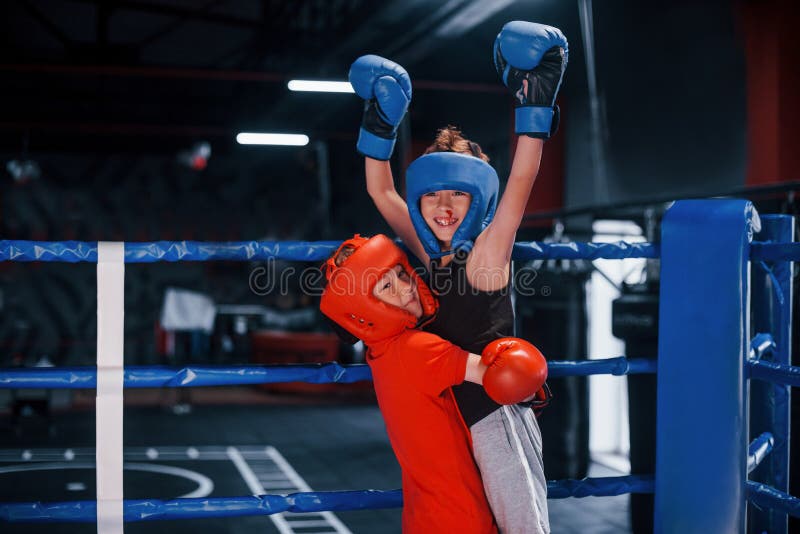 Portrait of Two Young Boys in Protective Gloves Celebrating Victory on