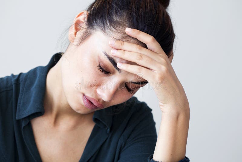 Portrait of unhappy woman on gray background stock photo Portrait of unhappy woman on gray background stock photo