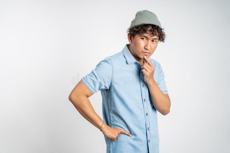 unsure asian young man thinking on isolated background