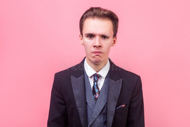 Portrait of upset stressed out businessman is about to cry, hopeless sadness expression. indoor studio shot isolated on pink royalty free stock photos Portrait of upset stressed out businessman is about to cry, hopeless sadness expression. indoor studio shot isolated on pink royalty free stock photos