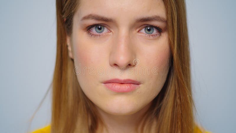 Portrait of upset woman looking at camera in studio.Unhappy girl crying.