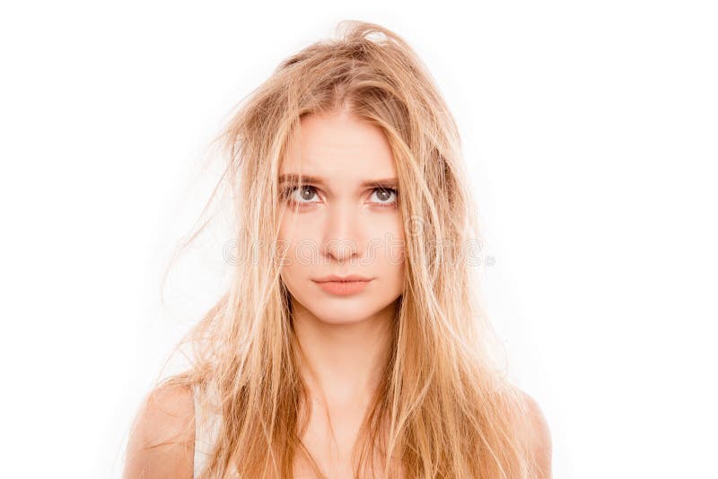 Portrait of upset young blonde woman woman with damaged hair.