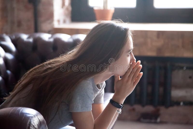 Portrait of a upset young woman in profile. royalty free stock photography