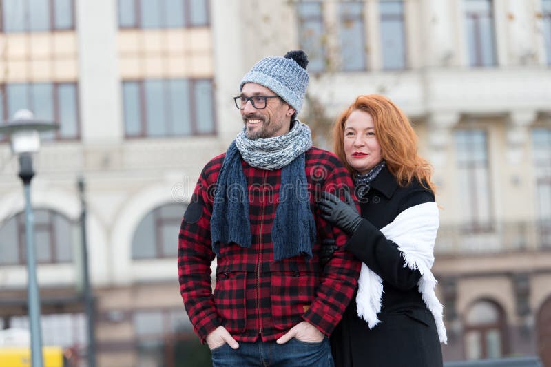 Urban people on urban background. Man and woman looking ahead. Couple waiting for city bus. Woman standing behind man`s back. stock photo Urban people on urban background. Man and woman looking ahead. Couple waiting for city bus. Woman standing behind man`s back. stock photo