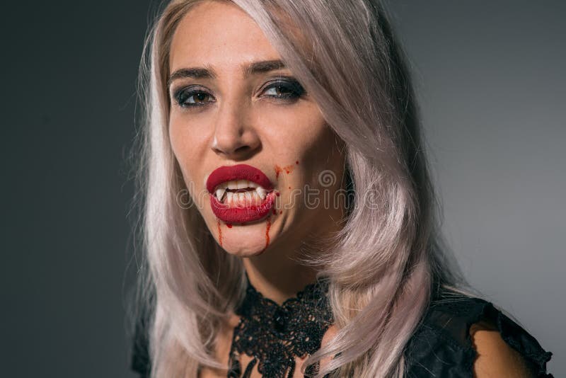 Vampire Woman with a Bloody Mouth and Teeth Fangs Celebrating a Stock ...