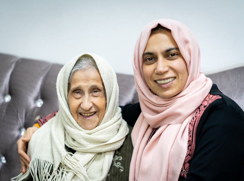 Portrait of very elder woman with daughter on sofa