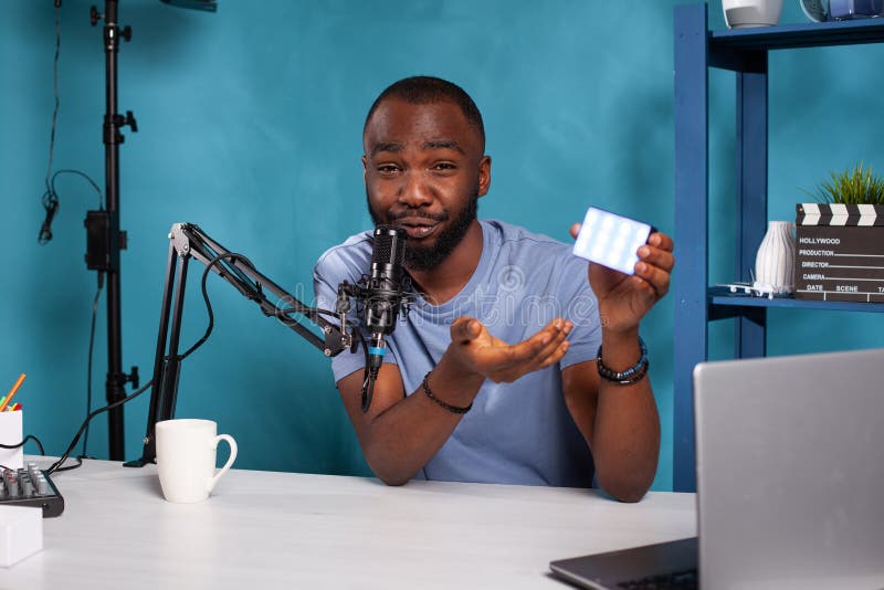 Portrait of vlogger presenting new model videography continous lighting on desk for vlog podcast royalty free stock photos