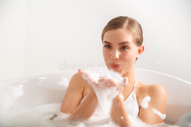 Young lass having fun in the bath