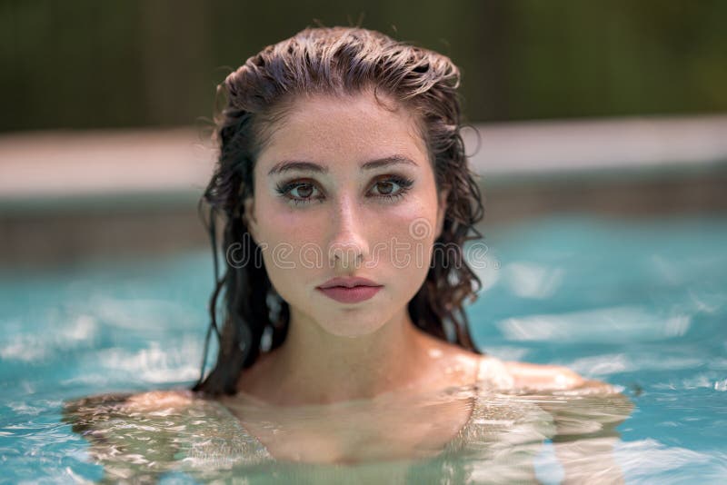 Portrait of a wet woman in the pool