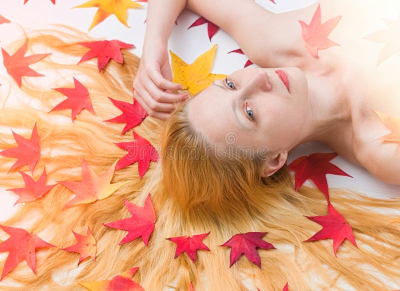 Portrait of the woman with colorful autumn leafs in the hair stock images Portrait of the woman with colorful autumn leafs in the hair stock images