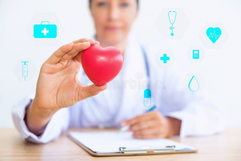 Portrait of woman doctor with holding red heart, Health care con